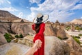 Women tourists holding man`s hand and leading him to Fairy Chimneys in Cappadocia, Turkey.