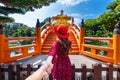 Women tourists holding man`s hand and leading him to Golden Pavilion in Nan Lian Garden near Chi Lin Nunnery temple, Hong Kong Royalty Free Stock Photo