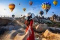 Women tourists holding man`s hand and leading him to hot air balloons in Cappadocia, Turkey. Royalty Free Stock Photo