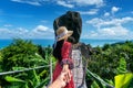 Women tourists holding man`s hand and leading him to overlap stone at Koh Samui, Thailand Royalty Free Stock Photo