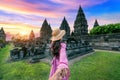 Women tourists holding man\'s hand and leading him to Prambanan Temple in Yogyakarta, Java, Indonesia Royalty Free Stock Photo