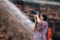 Women tourists taking pictures and background ancient brick at Yai Chaimongkol Temple, Thailand Royalty Free Stock Photo