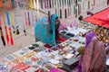 Women traded over a tray with cheap jewelry