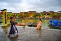 Asian women taking photos on canal in tourist destination Hoi An, Vietnamese women in Hoi An, Vietnam Royalty Free Stock Photo