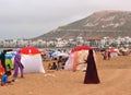 Women in traditional outfits playing tennis on the beach in Agadir, Morocco.