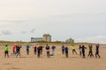 Women traing on the beach with Kijkduin resort in background Royalty Free Stock Photo