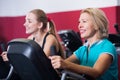 Women training on exercycle in gym-hall Royalty Free Stock Photo