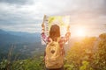 Women traveler with backpack checks map