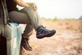 Woman traveller sitting on car at nature,Hiking shoes woman in beautiful view,Road trip Royalty Free Stock Photo