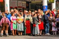 Women in typical bavarian dresses stand on the curb