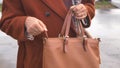 women Unzipping her purse close up