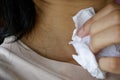 Women use tissue to absorb sweat