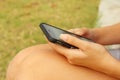 Women is using a phone in a garden