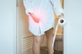 Women using toilet and suffers from Diarrhea and Hemorrhoids after wake up in morning at house Royalty Free Stock Photo