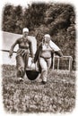 Women in Viking clothes carry a cauldron with food at the historical reconstruction