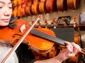 Women Violinist Playing A Violin In A Music Store Royalty Free Stock Photo