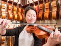 Women Violinist Playing A Violin In A Music Store Royalty Free Stock Photo