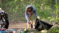 Women volunteers liquidate a large landfill. Illegal landfill in the forest spoils nature and ecology. Volunteers make