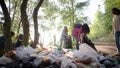 Women volunteers liquidate a large landfill. Illegal landfill in the forest spoils nature and ecology. Volunteers make