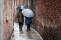 Women walk through a narrow alleyway street Royalty Free Stock Photo