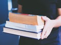 Women walking with books in hand to work