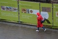 Women walking with hood during Raining day wet street, construction project in fischerinsel Royalty Free Stock Photo