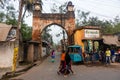Women walking past and ancient arched gateway on the streets of the old town of