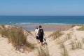 Women walking sand dune beach go to ocean atlantic sea in cap Ferret France