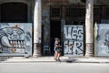 Young women walking in front of graffiti and morbid colonial architectur, Havana, Cuba Royalty Free Stock Photo