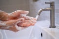 Women are washing their hands with foam soap and clean water. Wash your hands to keep them clean and prevent the spread of viral