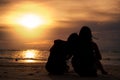 Women watching sunset together on beach Royalty Free Stock Photo