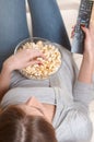 Women watching tv with popcorn at home. Top view Royalty Free Stock Photo