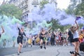 Women waving green and violet smoke flares in the air during 8M feminist strike