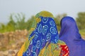 Women wear the colorful headscarfs with traditional pattern in the heat of india