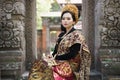 Women wear traditional Balinese kebaya between the relief gates Royalty Free Stock Photo