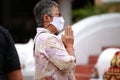 Women wear white mask praying to buddhism