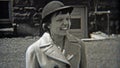 1937: Women wearing fashion hats like bollers.