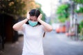 Women wearing green medical face mask showed anxiety-inducing headaches or stress while the coronavirus outbreak. Royalty Free Stock Photo