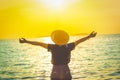 Women wearing a hat are enjoying a beautiful sunset on the beach Royalty Free Stock Photo