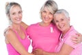 Women wearing pink tops and ribbons for breast cancer