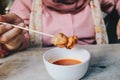 Women wearing pink veils eat Barbecue Meatballs Satay.