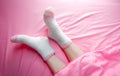 Women wearing socks in winter morning and blankets background. Warm and cozy on bedding sheet. Royalty Free Stock Photo