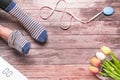 Women wearing strip sock sitting with white digital scale and measuring tape on the wooden background