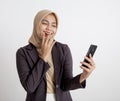 women wearing suits hijab laugh looking at the phone, formal work concept