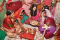Women wearing traditional indian outfits during wedding rituals