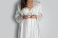 Women wearing white nightgown & long sleeve satin robe with floral lace