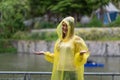 Women wearing yellow raincoat while raining in rainy season Royalty Free Stock Photo