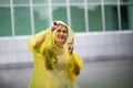 Women wearing yellow raincoat while raining in rainy season Royalty Free Stock Photo