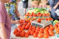 Women weighing fresh tomatoes for purchase at the market. Royalty Free Stock Photo