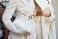 Women with white Fendi coat and bags with golden details before Fendi fashion show, Milan